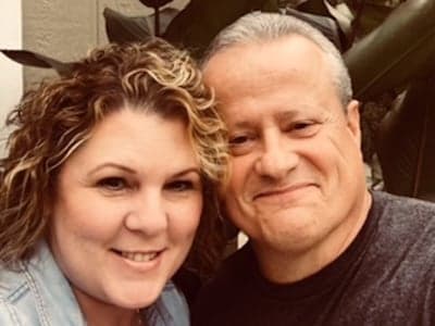 Women and man in their mid-50s together smiling